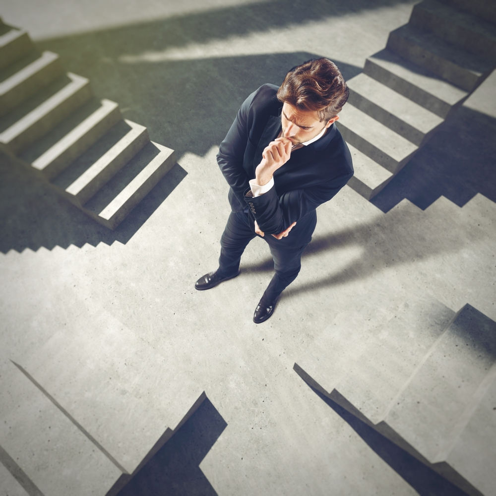 businessman,undecided,on,what,scale,must,climb
